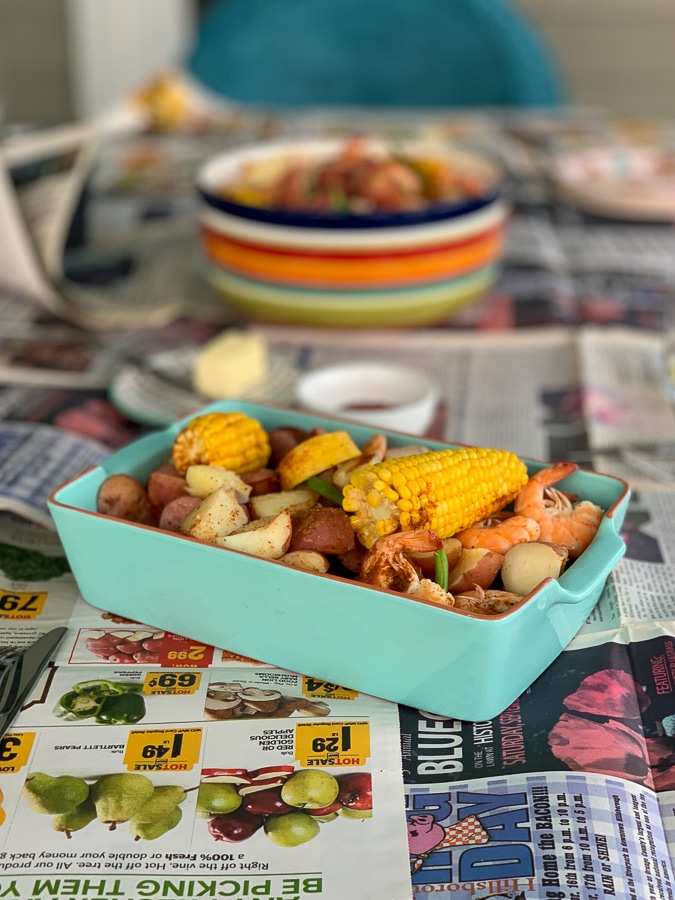 small blue dish with corn, shrimp, potatoes