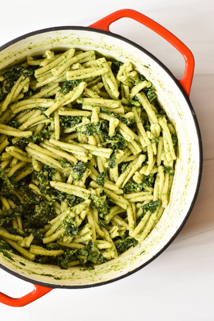 pasta salad with kale and pesto in a dutch oven