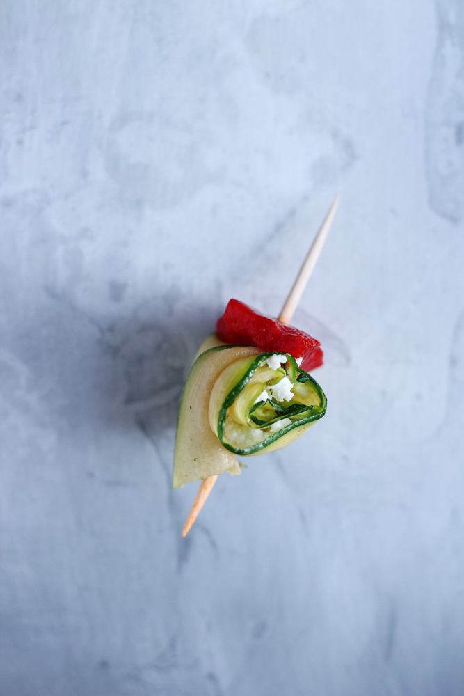 Zucchini and goat cheese rolls on a toothpick