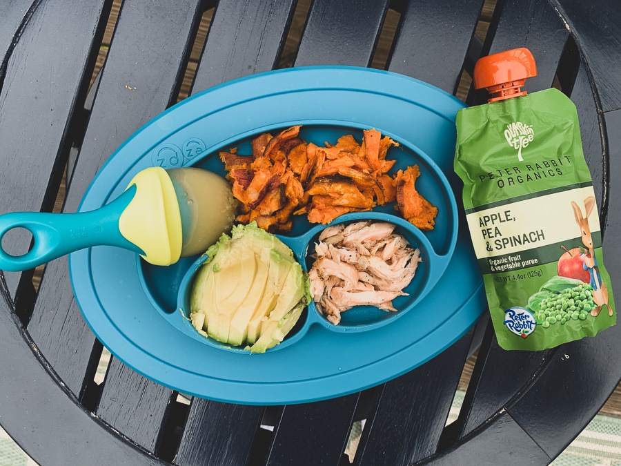 Baby led weaning meal with finger foods of sweet potatoes, avocado, salmon