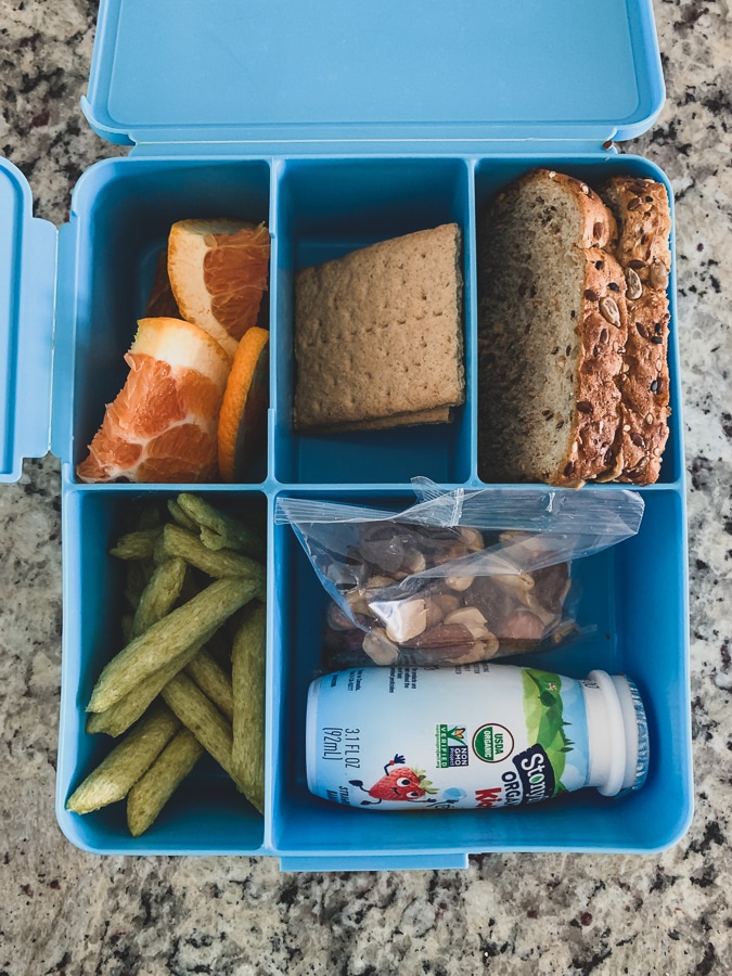 blue pottery barn bento lunchbox filled with food