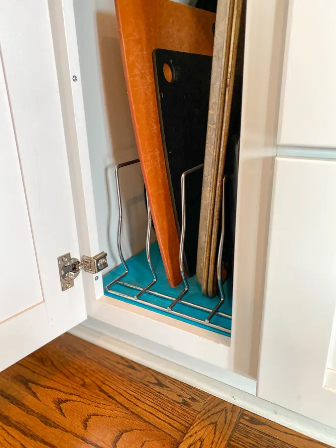 baking sheets and cutting boards organized on a rack