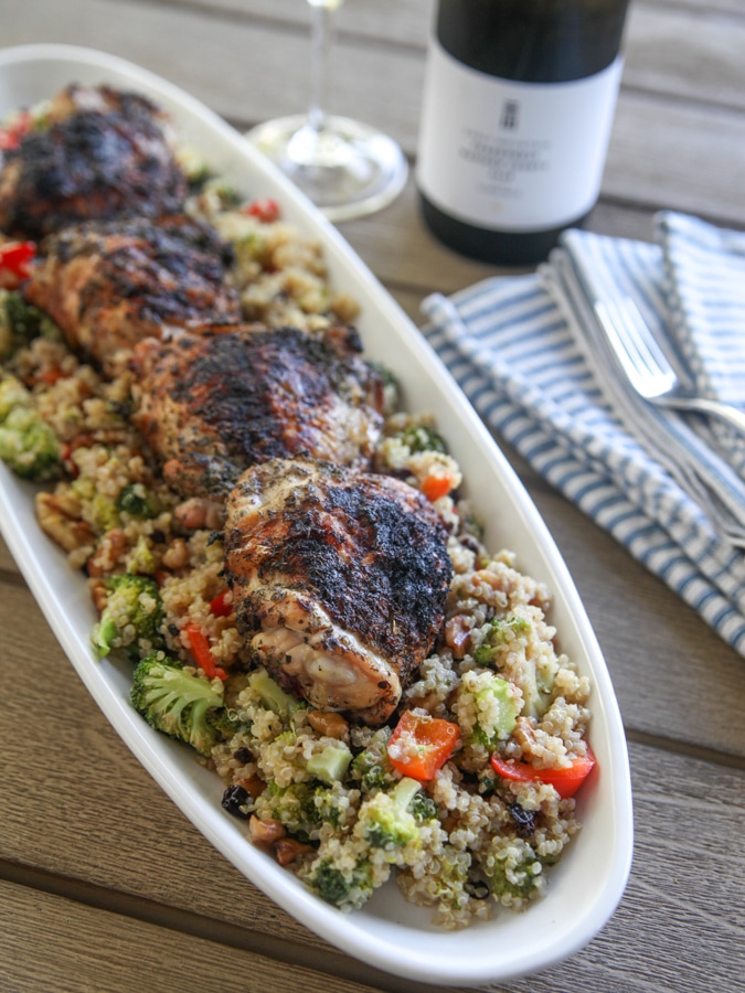 a long plate with quinoa salad and chicken with wine