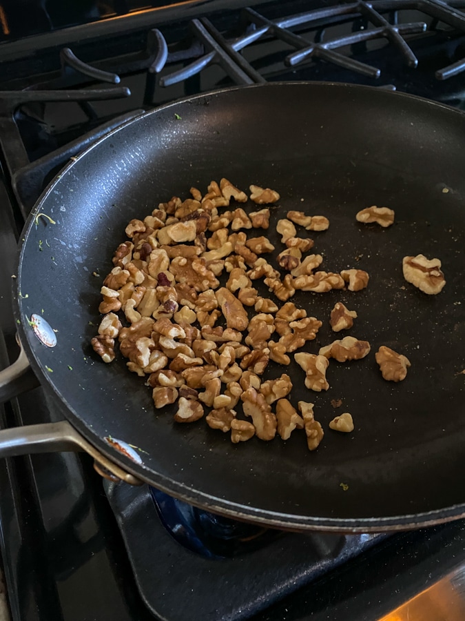 walnuts toasting in a skillet