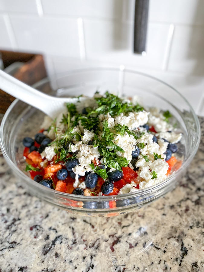 prep bowl of quinoa salad with feta