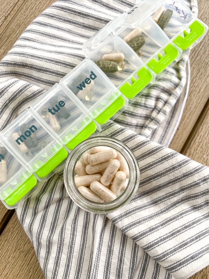 Routine probiotic capsules on a napkin with a pill case