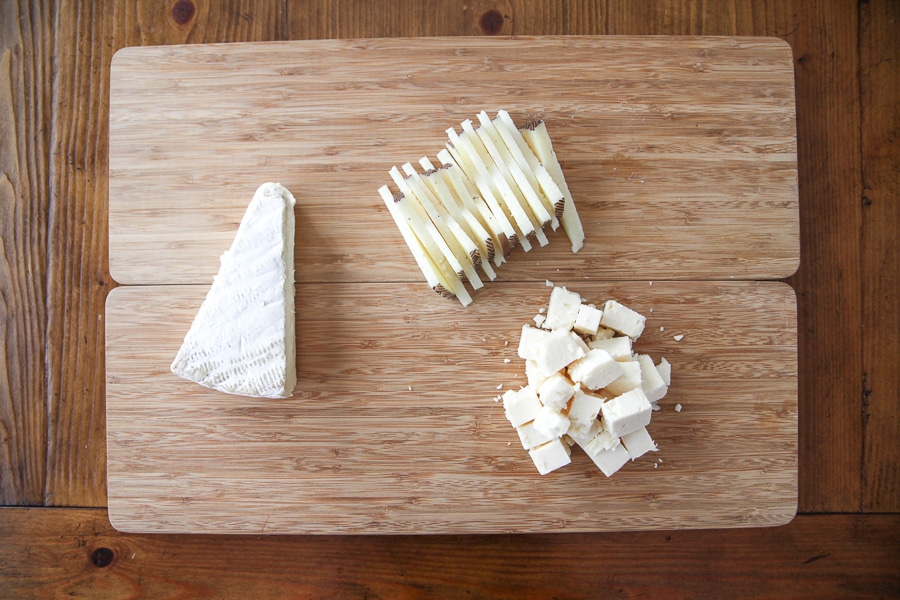 cheeses on a cutting board