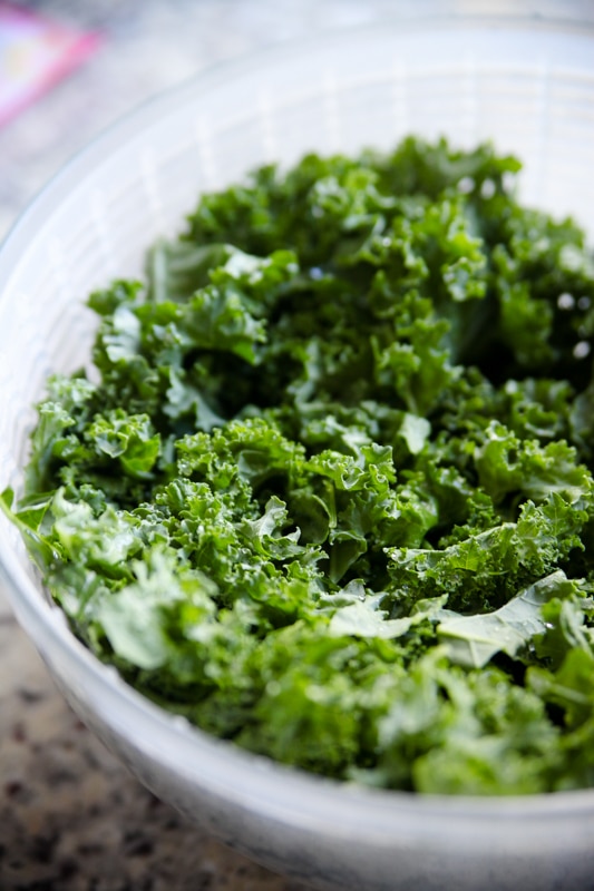 raw kale in salad spinner