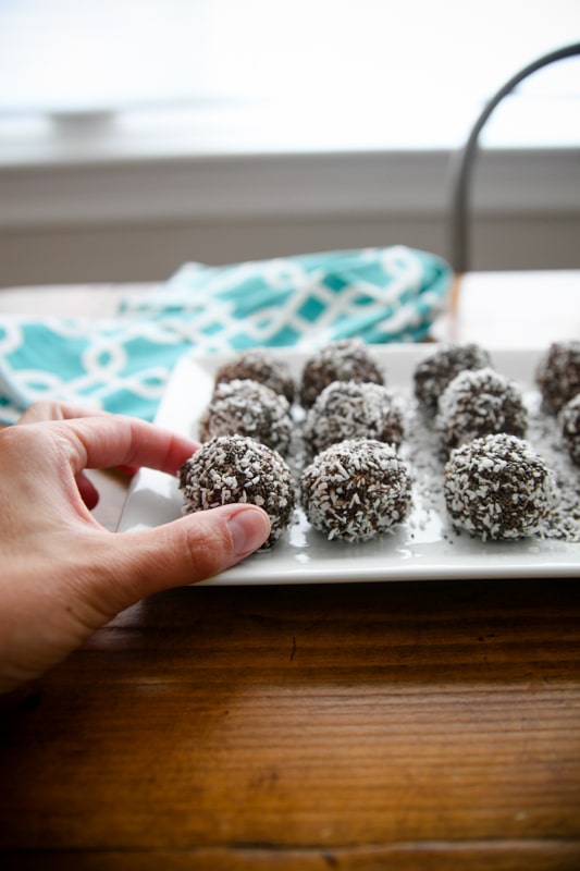 hand picking up a chocolate truffle