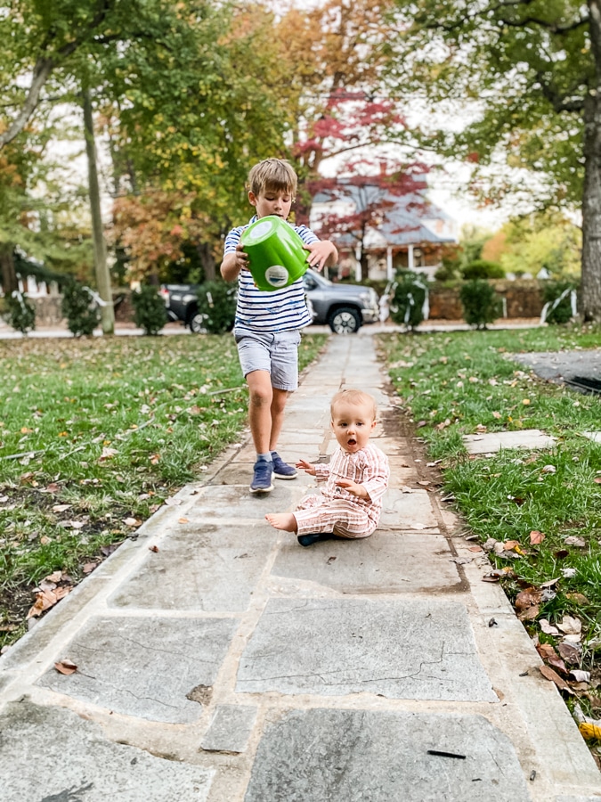 brothers on a sidewalk in the fall