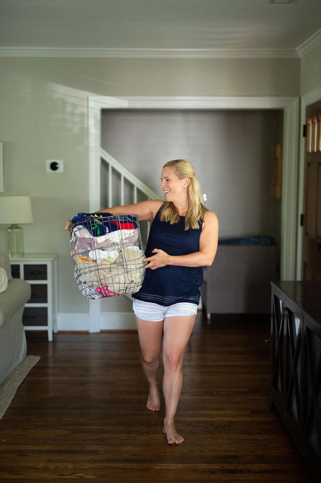 woman holding basket of laundry | woman holding basket of laundry