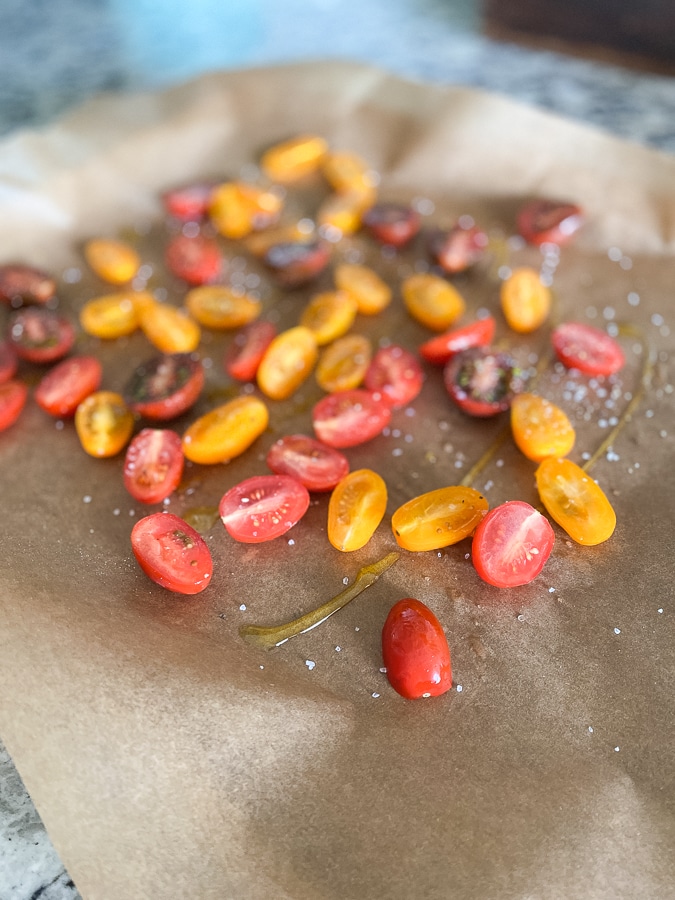 sliced cherry tomatoes on parchment paper
