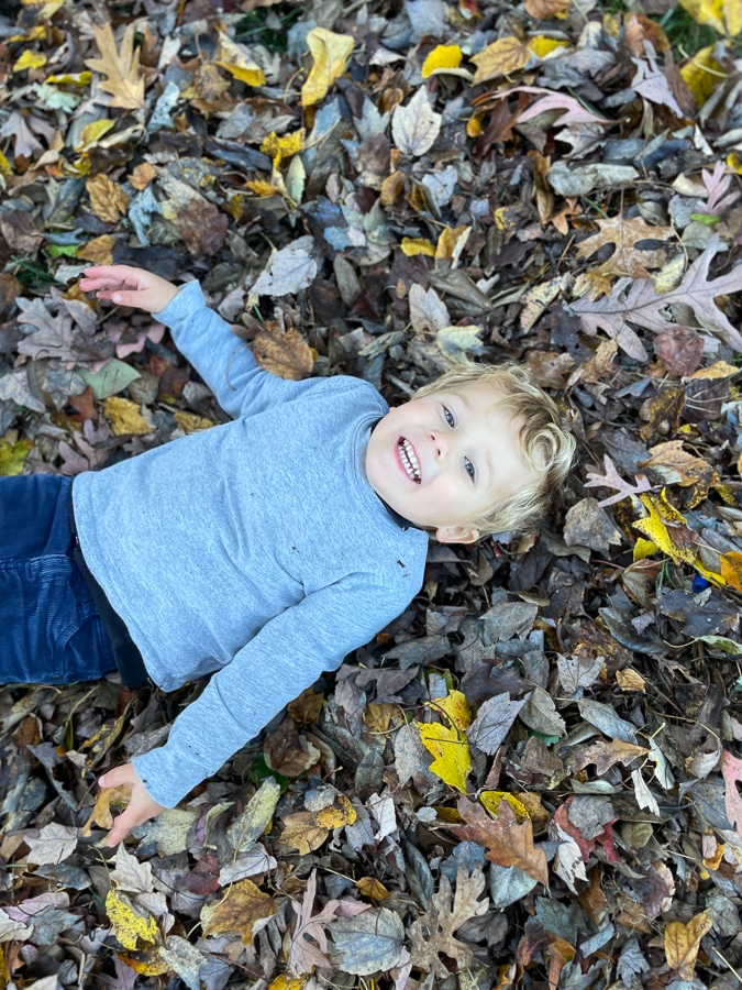 toddler on fall leaves