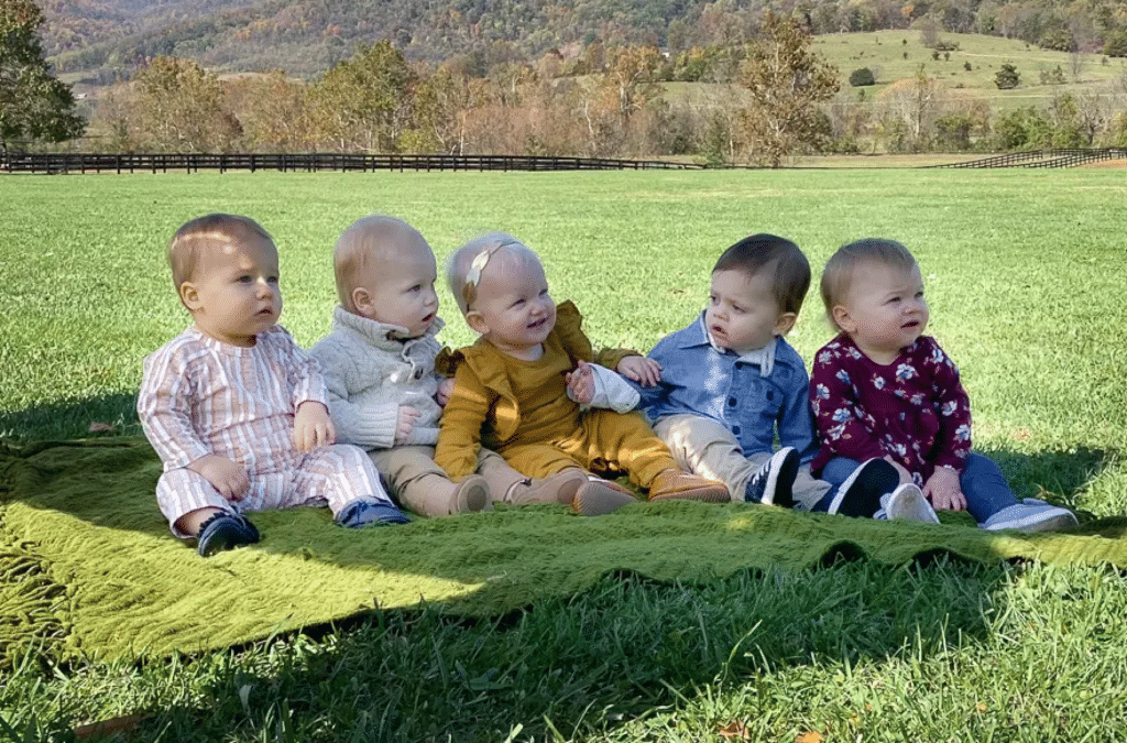 5 babies on the grass