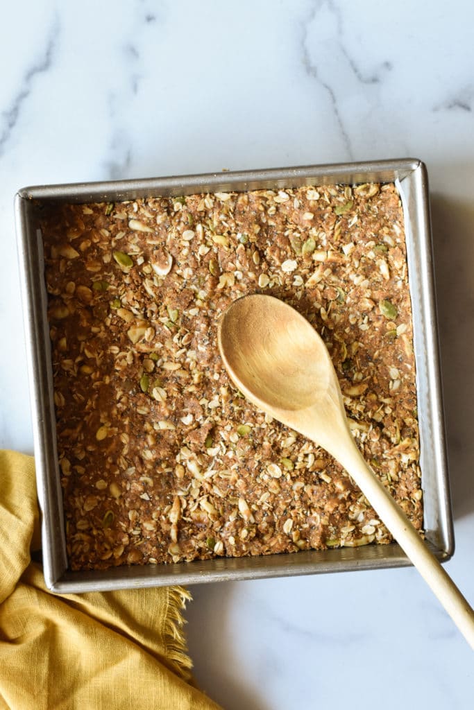 energy bars in a pan with wooden spoon