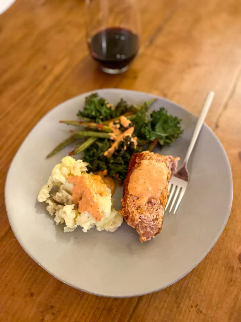 Meatloaf, mashers, and kale chips with green beans
