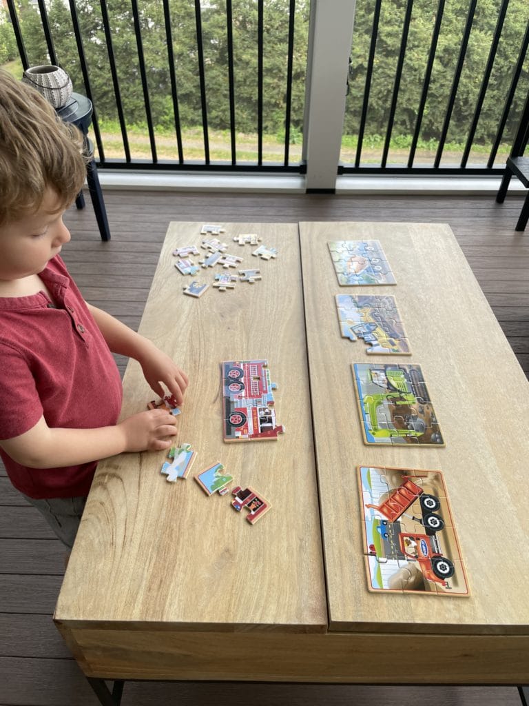 little boy playing puzzles