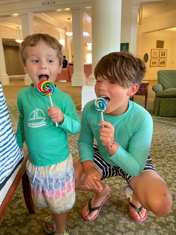 little boy licking lollipops