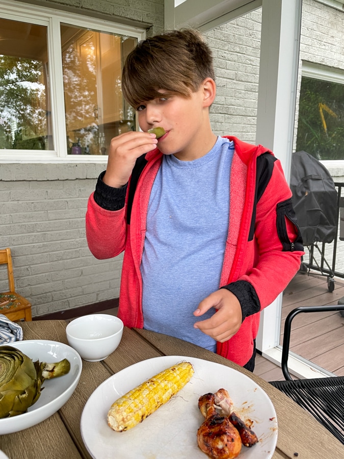Boy eating Artichoke