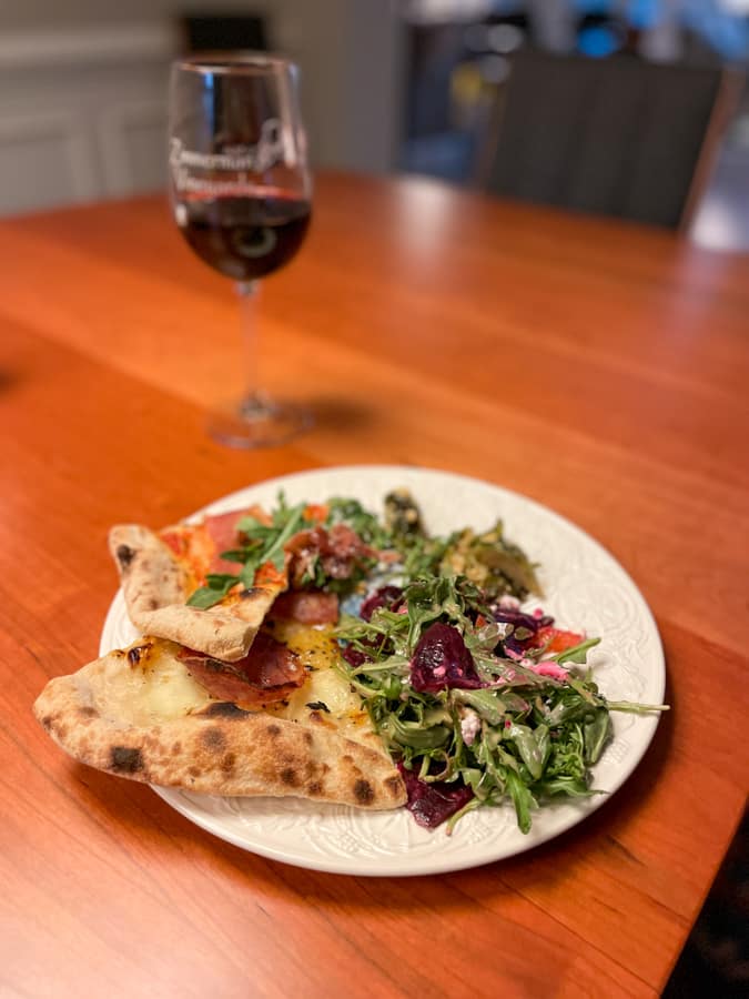 plate of pizza with salad