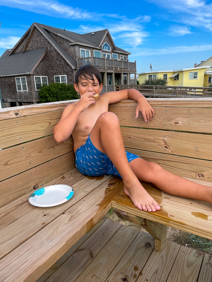 boy lounging by the hot tub | Fall Trip To OBX