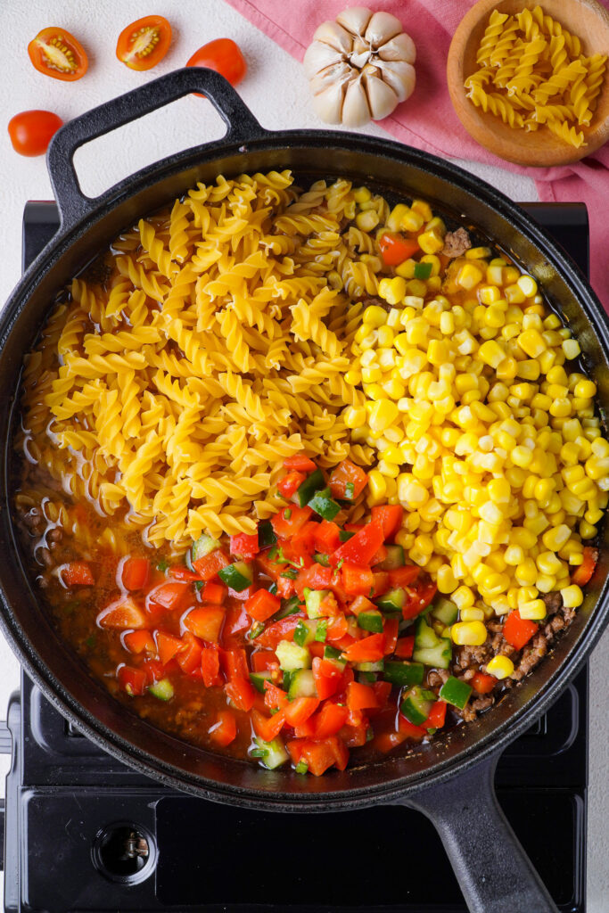 Add water, pasta, pico, and corn
