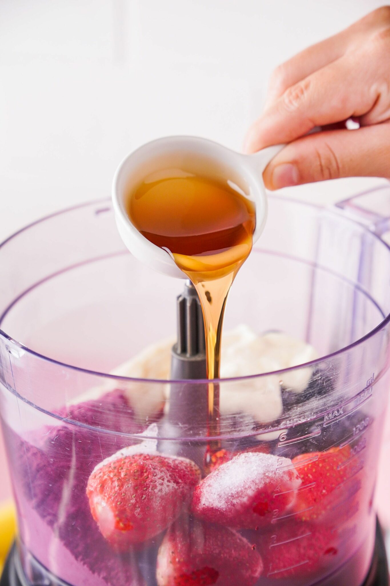 How To Make An Acai Bowl // pouring maple syrup into blender