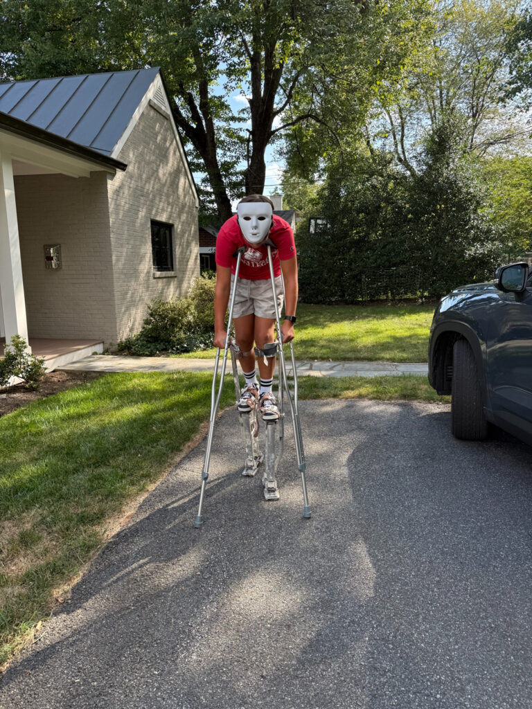 Mazen practicing stilts for Halloween