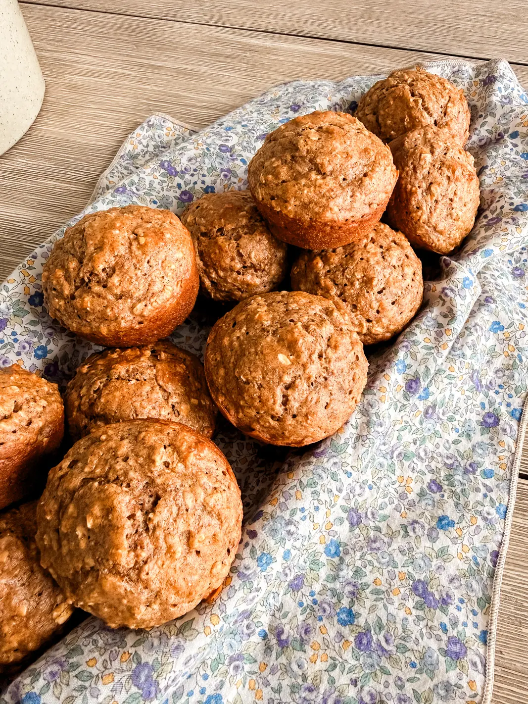 Basket of whole wheat muffins on a floral napkin