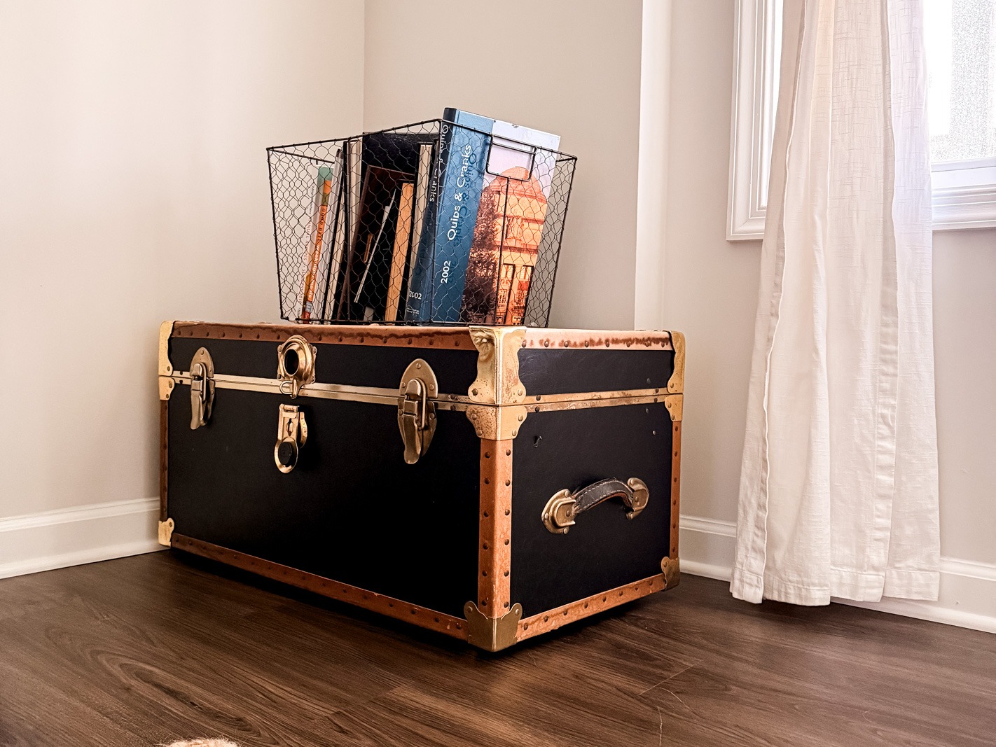 a trunk with a stack of books on top