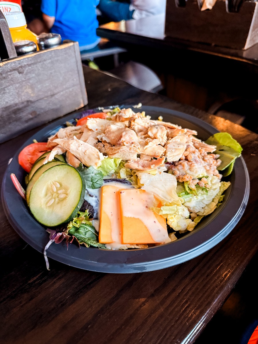 A rotisserie salad with cheese and cucumbers