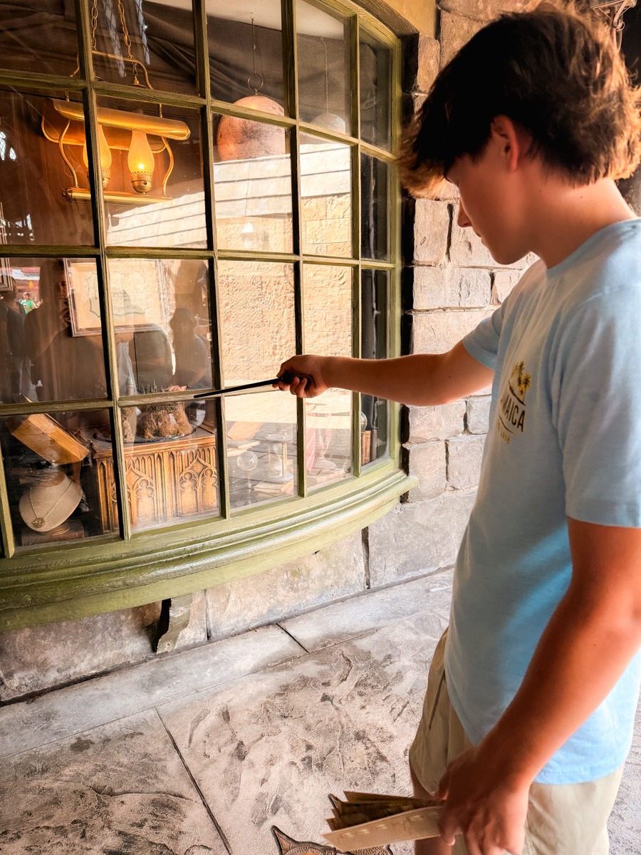 Mazen casting a spell with a wand at Universal Islands of Adventure