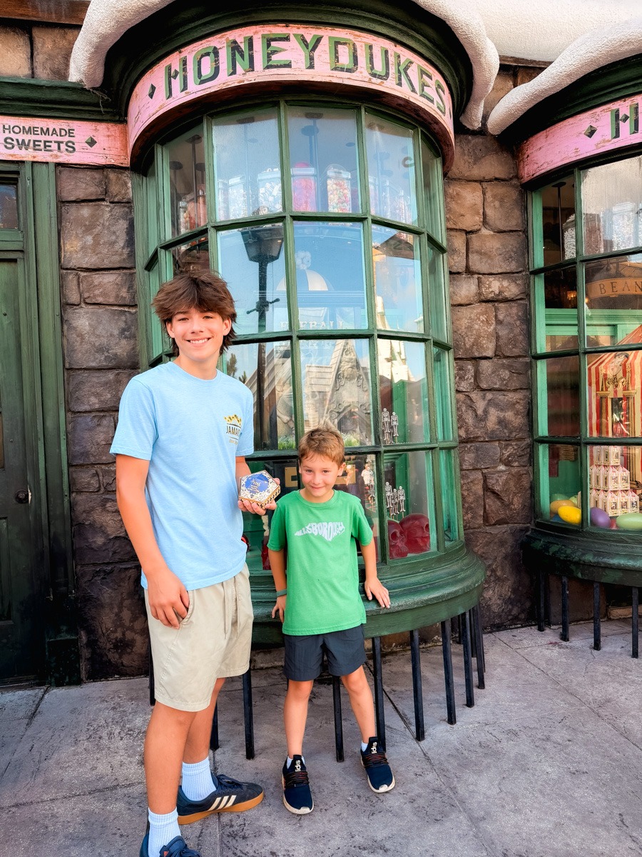 Honeydukes with kids outside of the store at Universal Islands of Adventure