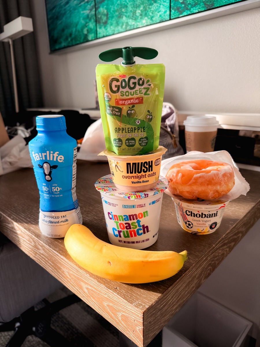 Breakfast before Universal Islands of Adventure with applesauce, milk, cereal, and overnight oats, donut